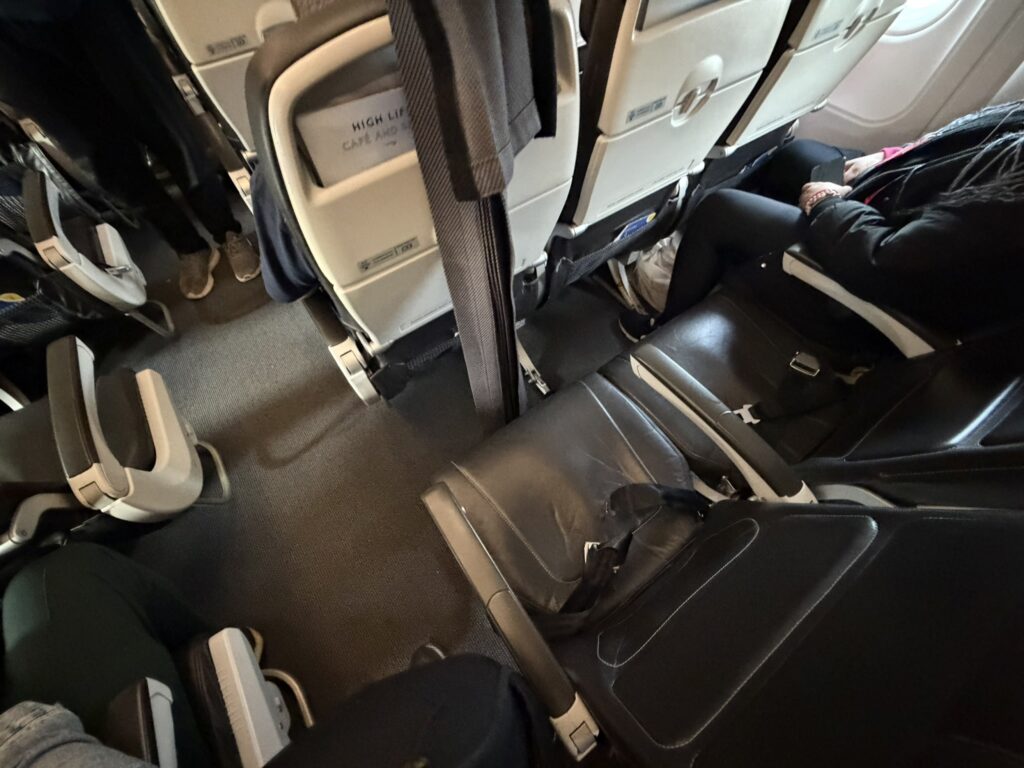 Inside the BA cabin a curtain is hanging in front of a seat. 