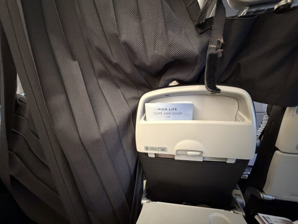A curtain is pushed up against the seat in front of the passenger. 