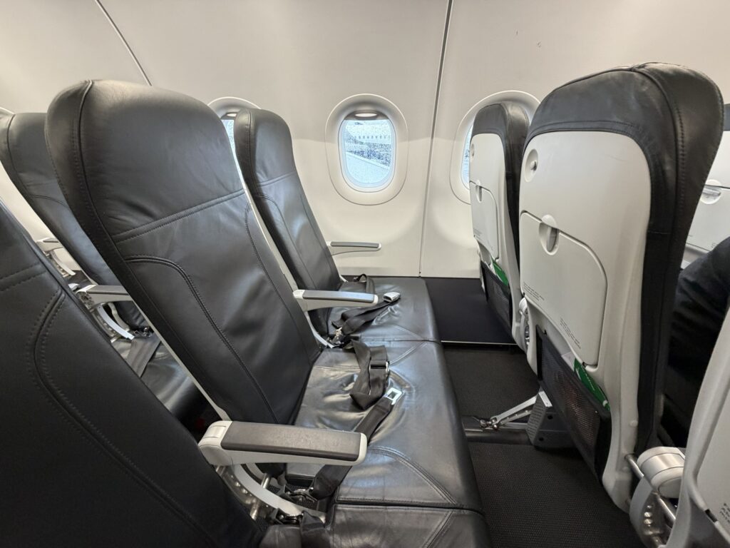 BA A321neo cabin sits empty for passengers. This image shows a seat triple of grey slimlines