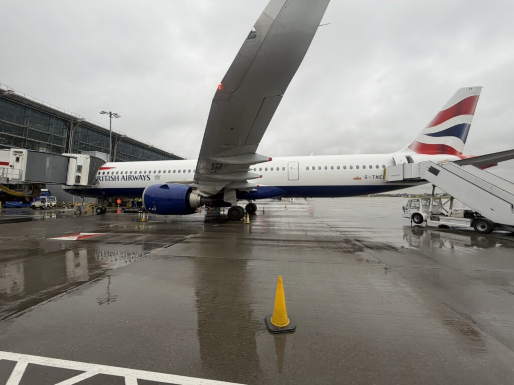 BA aircraft at the gate for boarding but the back of the aircraft also has stairs outside for boarding as well.