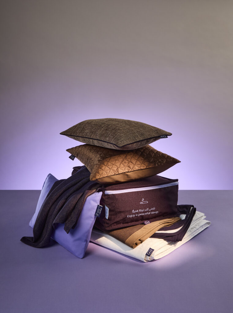 Riyadh Air first class bedding items, stacked on top of each other, as designed by John Horsfall