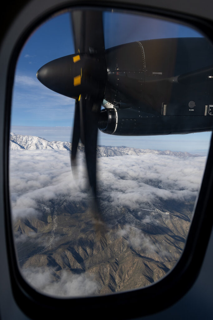 Looking out the aircraft window to see the propeller.