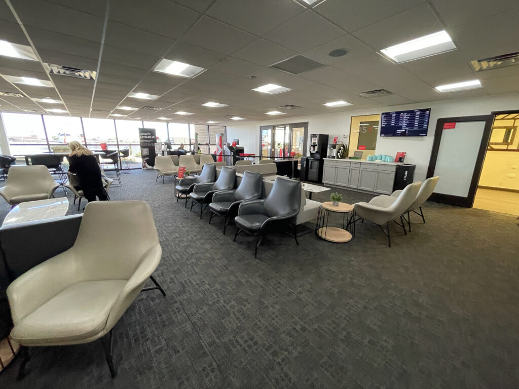 JSX lounge is fairly empty of passengers. 