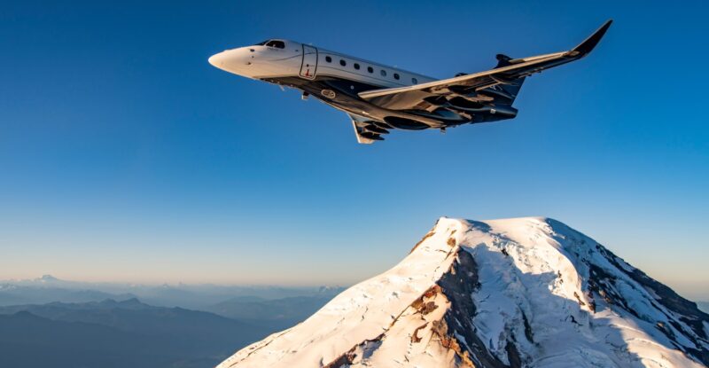 Praetor 600E in flight over snowy mountains.