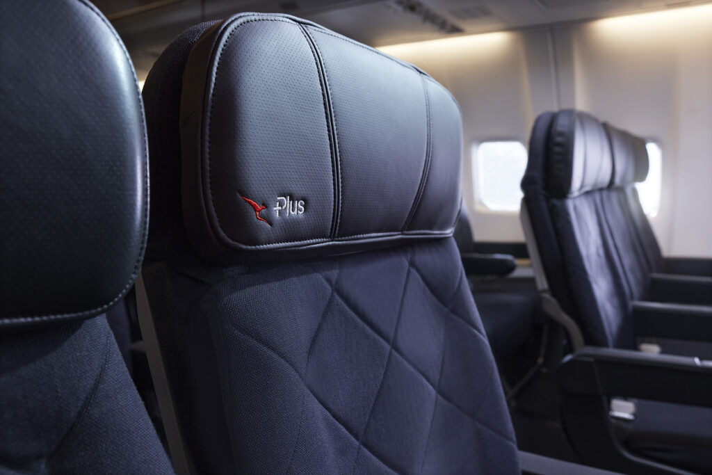 A close up of a Qantas Economy Plus  headrest. The seat has a diamond pattern within the fabric.