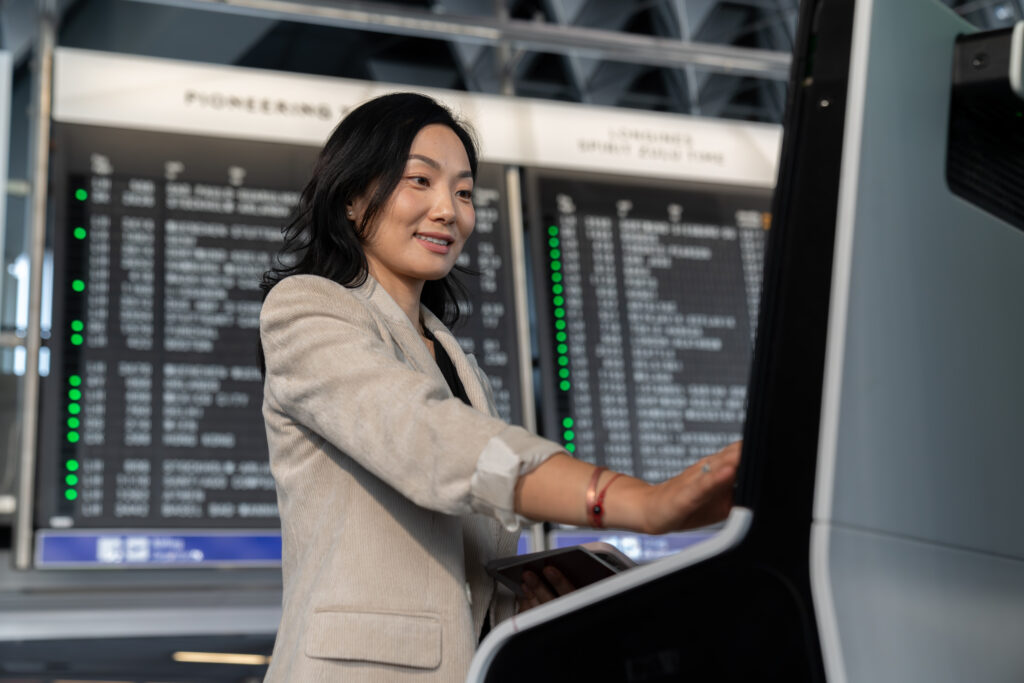 Woman uses a SITA kiosk at Kobe Airport