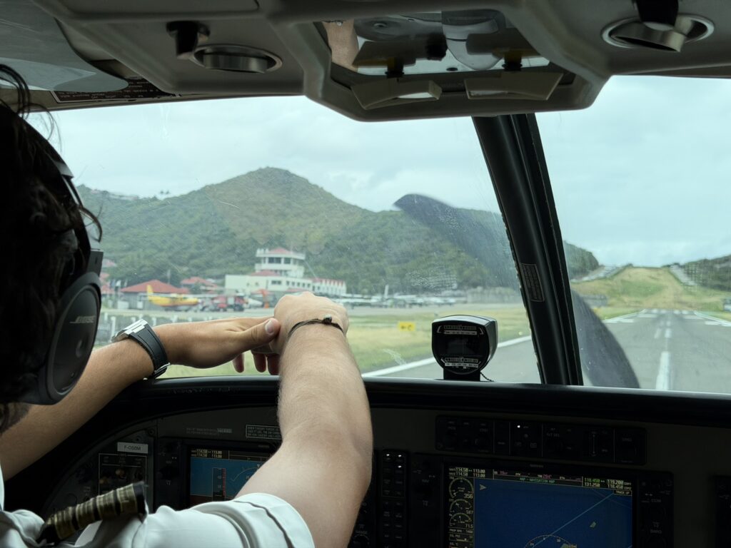 The pilot sits in a relaxed state after landing the aircraft.