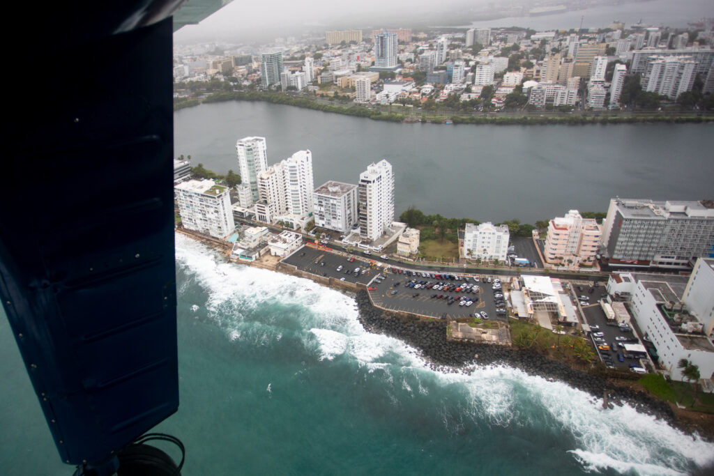 Looking out the aircraft window to a coastal view.