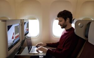Passenger on board SWISS widebody enjoys Starlink inflight Wi-Fi on his laptop. SWISS is a member of the Lufthansa Group