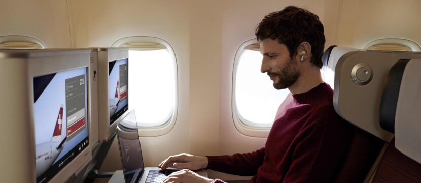 Passenger on board SWISS widebody enjoys Starlink inflight Wi-Fi on his laptop. SWISS is a member of the Lufthansa Group