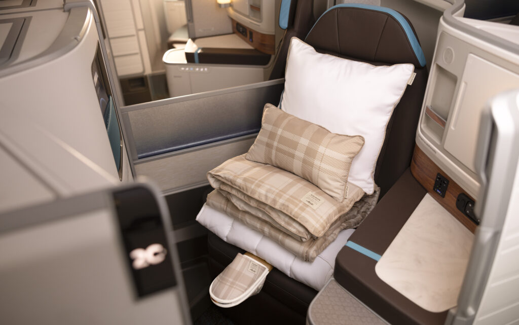 Blankets and pillows are stacked on the seat
