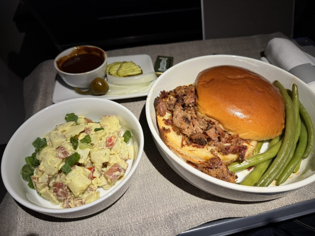 Pecan Lodge smoked chopped brisket sandwich with sides.