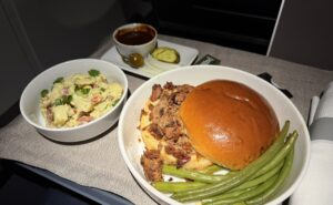 Pecan Lodge smoked chopped brisket sandwich with sides.