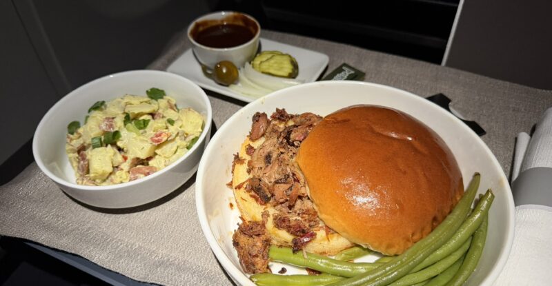 Pecan Lodge smoked chopped brisket sandwich with sides.