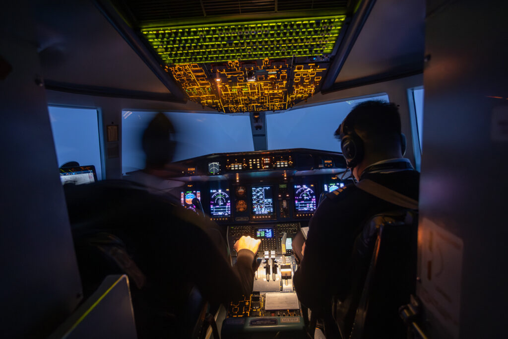 Looking through a window on the aircraft into the cockpit. 