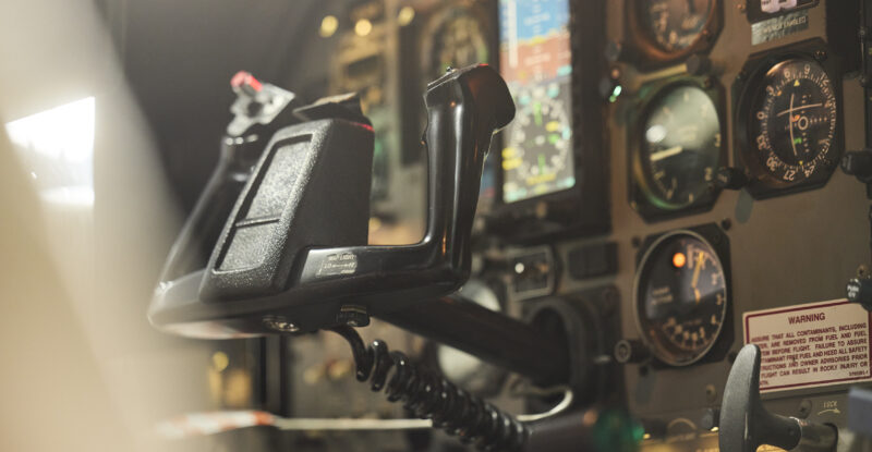 Inside a cockpit that is showing no pilot at the controls.