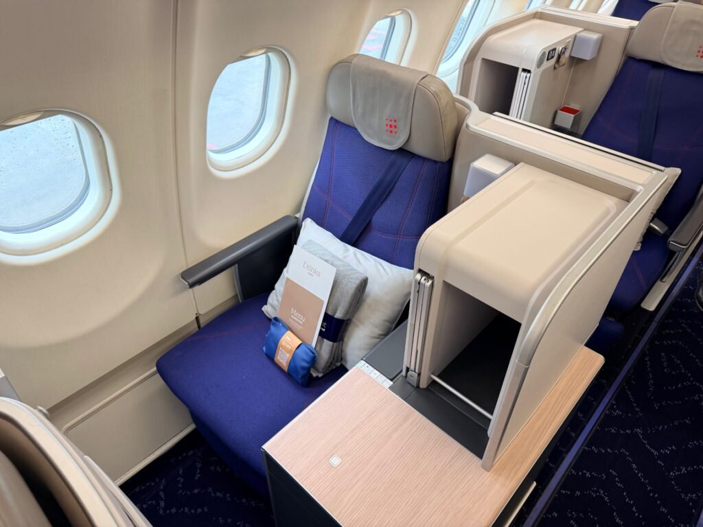 Brussels Airlines business class seat in blue with grey accents.