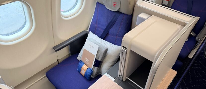 Brussels Airlines business class seat in blue with grey accents.