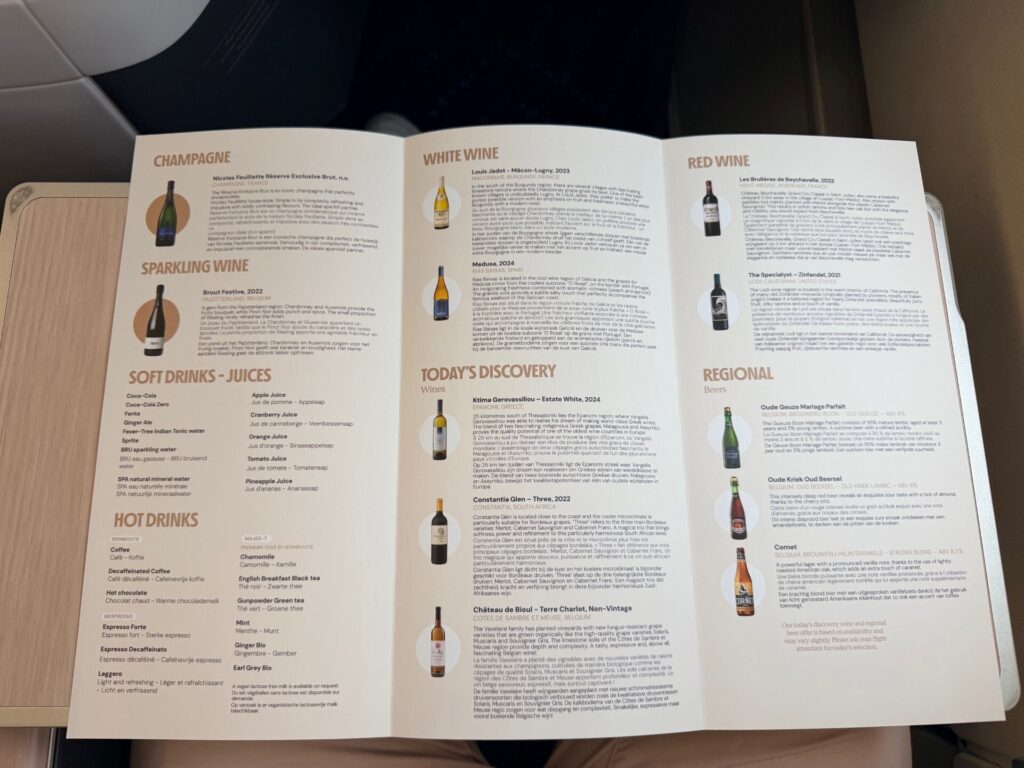 A Brussels Airlines menu is opened on the aircraft tray table.