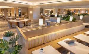 Korean Air LAX Prestige Class Lounge features long sofas, and a variety of different chairs and tables.