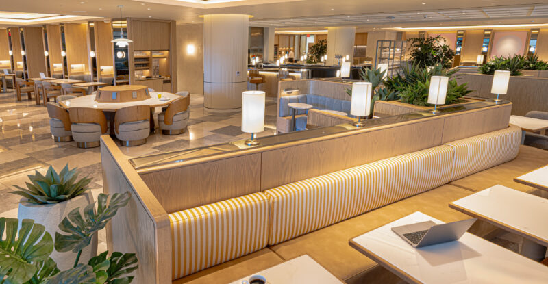 Korean Air LAX Prestige Class Lounge features long sofas, and a variety of different chairs and tables.