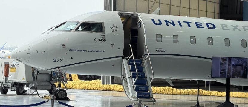 United Airlines CRJ-450 at an LAX hanger during a media event.