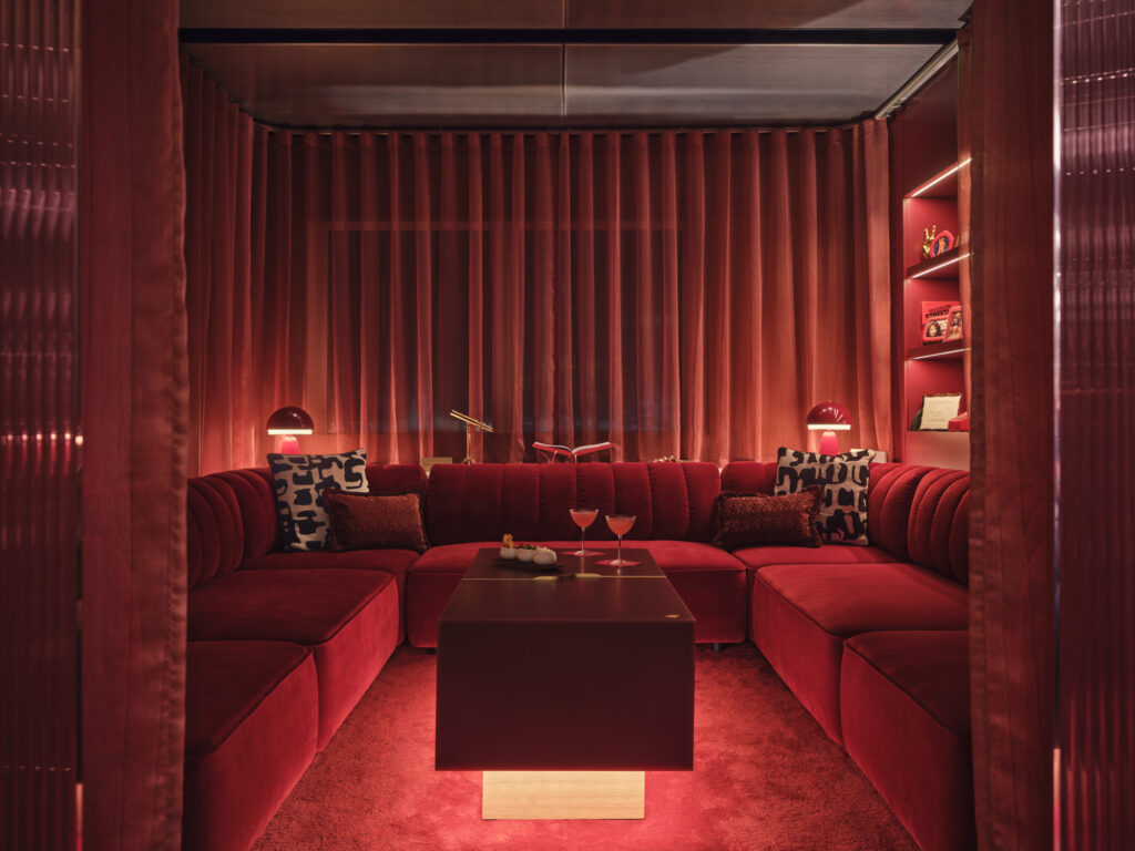 Royal Box in the Virgin Clubhouse at LHR features red sofas, curtains and carpet 