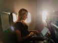 A female passenger is using her laptop in flight with SAS wi-fi powered by Starlink.