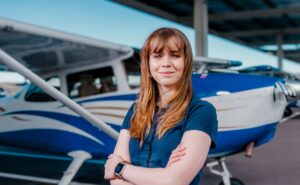 Cassidy Blackwood, student of Embry‑Riddle Aeronautical University is standing in front of an aircraft.