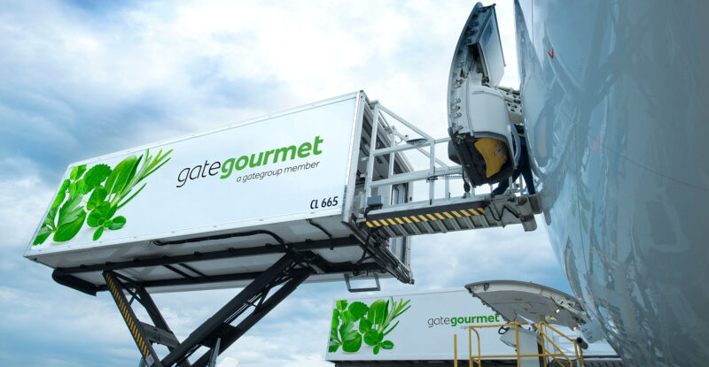 gategroup catering items are being loaded onto an aircraft.