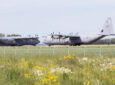 Two Royal Canadian Air Force Hercules C-130, with identifications 603 and 609, preparing for takeoff at Edmonton International Airport.