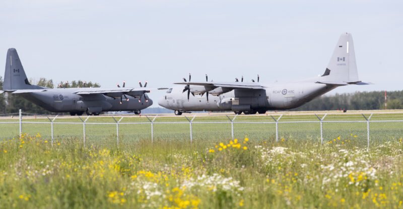 Two Royal Canadian Air Force Hercules C-130, with identifications 603 and 609, preparing for takeoff at Edmonton International Airport.