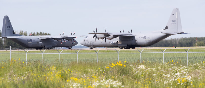 Two Royal Canadian Air Force Hercules C-130, with identifications 603 and 609, preparing for takeoff at Edmonton International Airport.