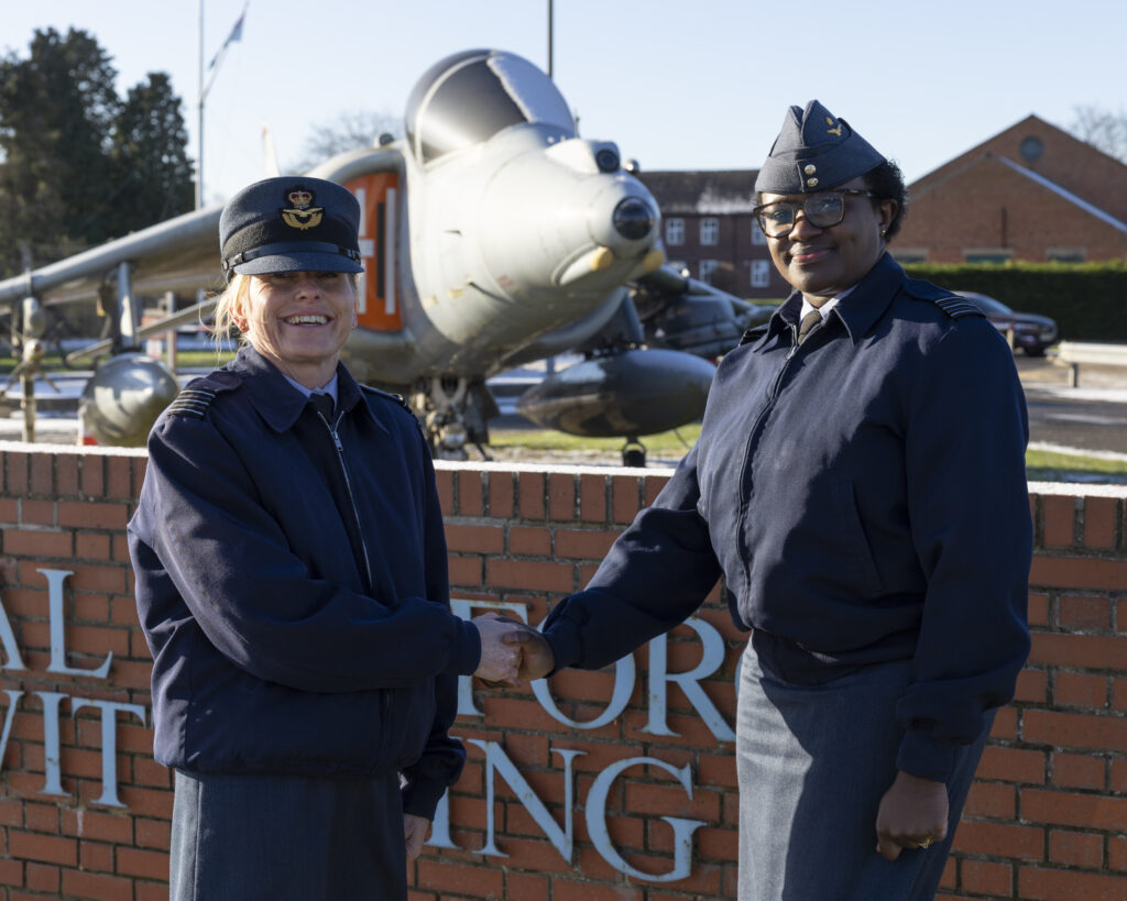 The image shows Wing Commander Nicola Duncan shaking hands with Wing Commander Joan Ochuodho on the day of the station commander handover. On January 5th, 2026, RAF Wittering saw the handover of station commander from Wing Commander Nicola Duncan to Wing Commander Joan Ochuodho.