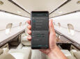 A mobile device is being held up in a bizjet aircraft. It is displaying the ALTO MySound app.