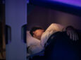 A passenger is sleeping in the Skynest.