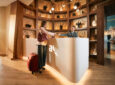 A passenger is checking into the Avianca Diamond International VIP lounge.