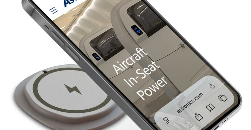 A mobile device is charging using the EmPower Qi21 Wireless Charging Module.