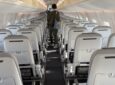 Inside the the Finnair E190 aircraft with pale, slimline seats and a very bright and airy cabin