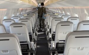 Inside the the Finnair E190 aircraft with pale, slimline seats and a very bright and airy cabin