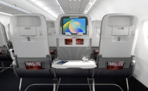 Seatbacks of Collins Helix seats. A device sits on a device holder in the middle seat. AIX 2026
