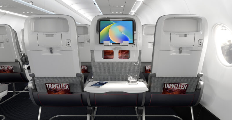 Seatbacks of Collins Helix seats. A device sits on a device holder in the middle seat. AIX 2026