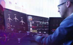 Man views aircraft ops data on multiple screens