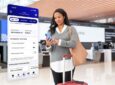 A United passenger is seen here using their mobile device for the new app. A picture of the new app interface is beside them.