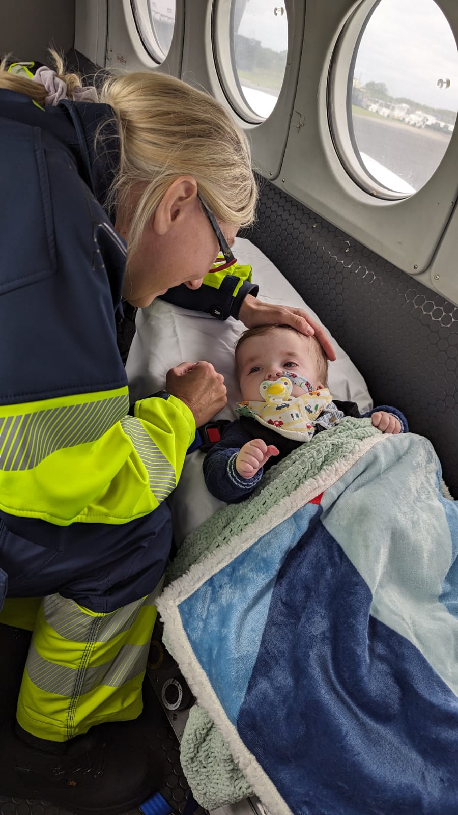A Lia's Wings flight nurse is tending to a critical child in flight. 