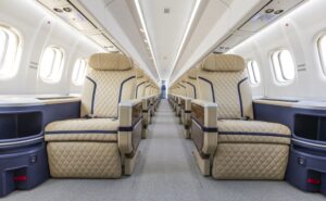 ATR HighLine all-business cabin for Berjaya Air. Seats are cream with blue piping and beige headrests.