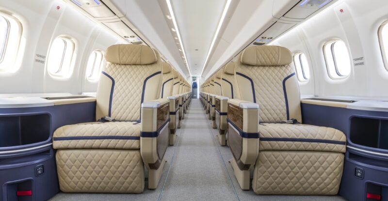 ATR HighLine all-business cabin for Berjaya Air. Seats are cream with blue piping and beige headrests.