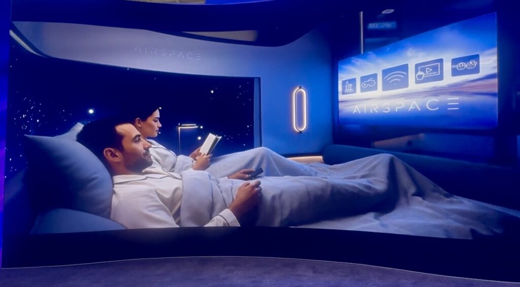 Two passengers tuck into the double bed, preparing to sleep in the center suite