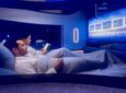 Two passengers tuck into the double bed, preparing to sleep in the center suite