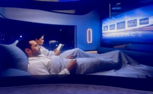 Two passengers tuck into the double bed, preparing to sleep in the center suite
